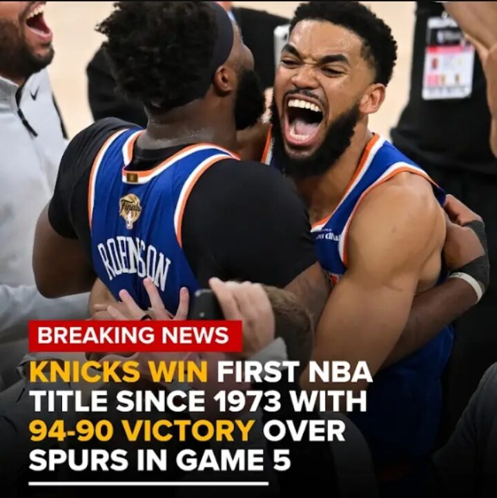 New York Knicks players lifting the Larry O'Brien Trophy in San Antonio.